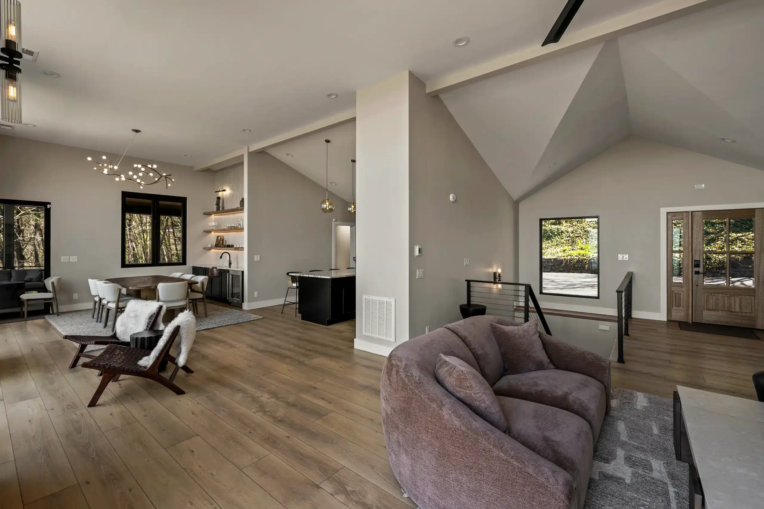 Open-concept luxury living space with vaulted ceilings and white oak floors in a WNC custom home