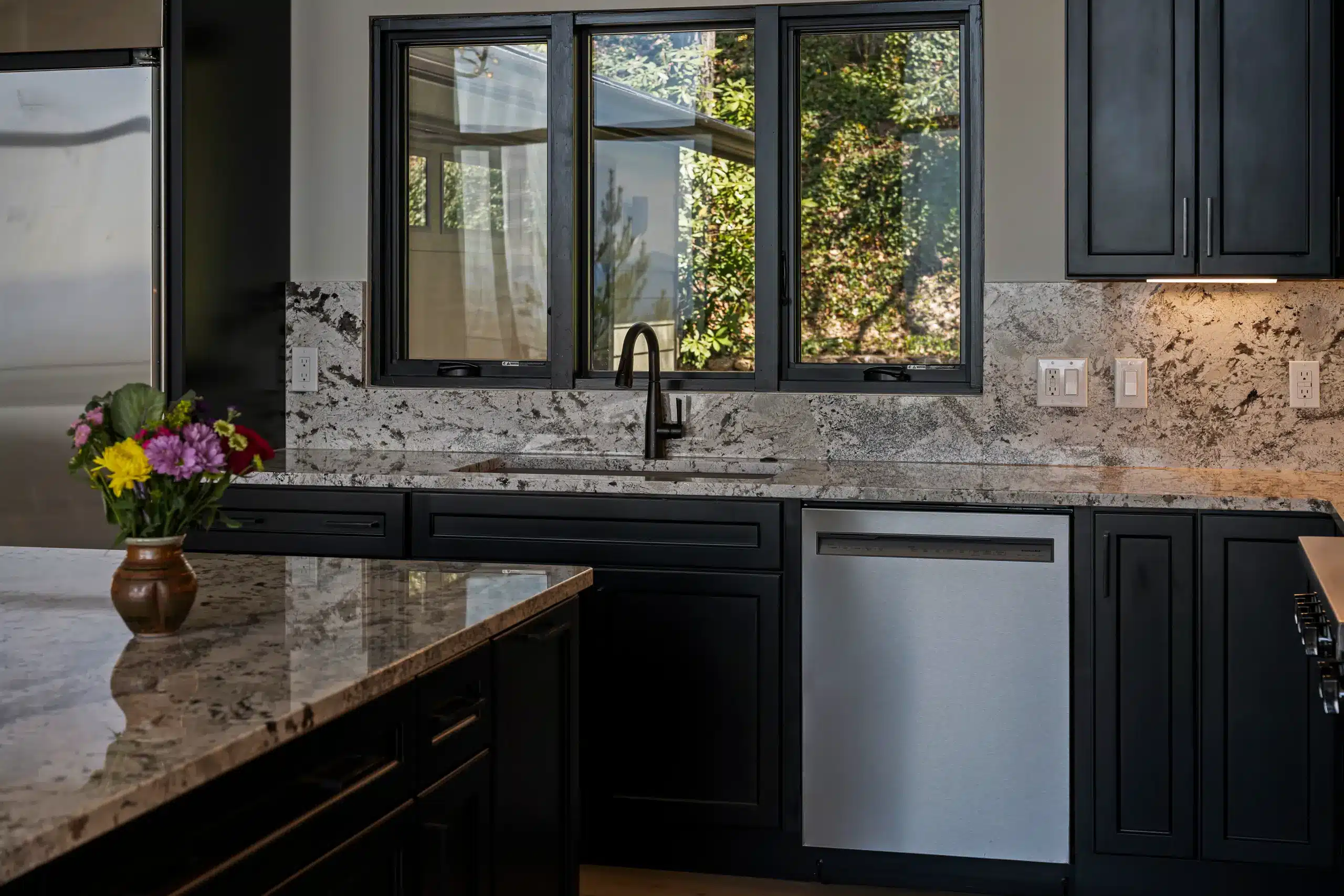 Custom luxury kitchen with black cabinetry and granite in an Asheville mountain home