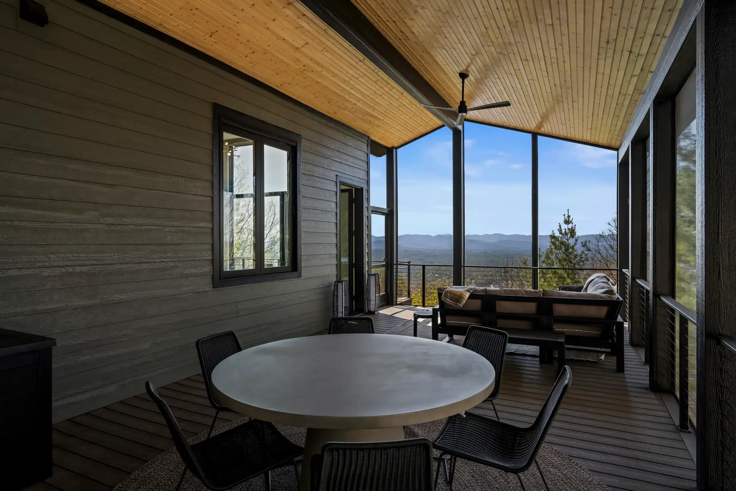 Cantilevered screened deck overlooking a wooded WNC mountain landscape